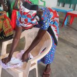 A community member practicing how  a pad is worn